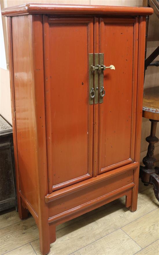 A Chinese red lacquer round corner cabinet, W.68cm